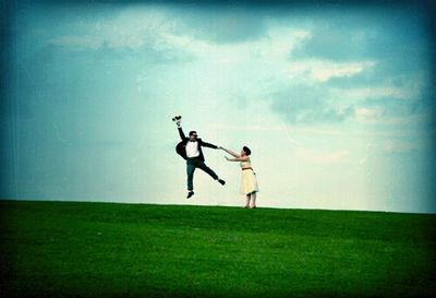 Scenic view of grassy field against sky