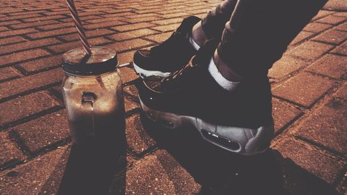 Low section of person standing on footpath