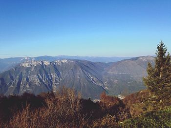 Scenic view of mountains against clear blue sky