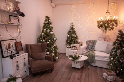 Illuminated christmas tree on floor at home