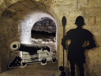 Shadow of man standing on tiled floor