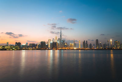 Illuminated city at waterfront