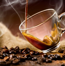 Close-up of coffee beans in glass on table