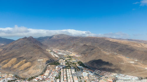 High angle view of mountains against cloudy sky