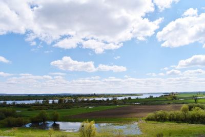 Scenic view of landscape and sea against sky