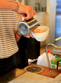 Close-up of hand holding coffee cup