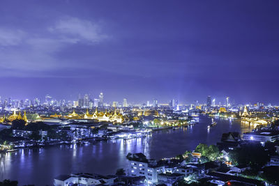 High angle view of city lit up at night