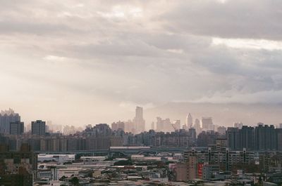 High angle view of buildings in city against sky