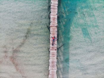 High angle view of people on pier at beach