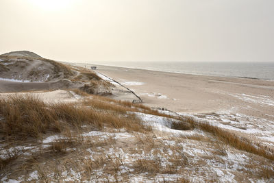 Scenic view of sea against sky during winter