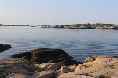 Rocks on beach against clear sky