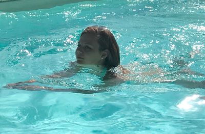 Boy swimming in pool