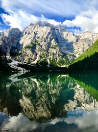 Scenic view of lake and mountain against cloudy sky