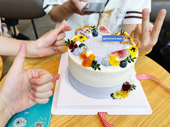 Midsection of woman holding birthday cake