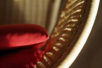 Close-up of cushion on wicker chair