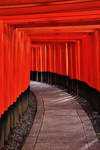 View of empty corridor of temple with red wooden palisades