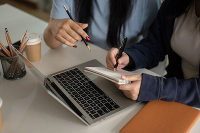 Midsection of woman using laptop