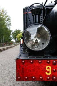 Close-up of red car on road against sky