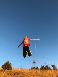 Man jumping against clear sky