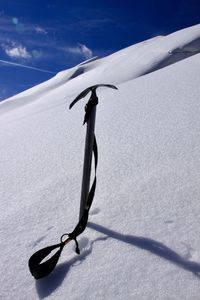 Shadow of person on snowcapped mountain against sky