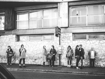 People standing by window in city