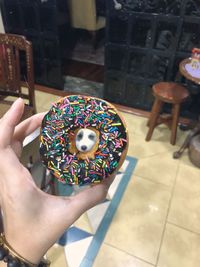 Midsection of person holding ice cream on table