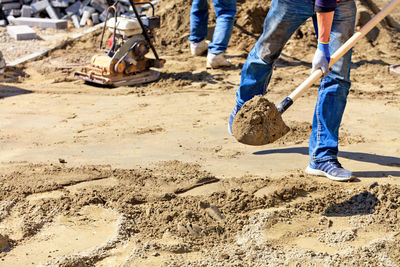 Low section of men working at construction site