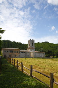 Built structure on field against sky