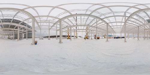 Spherical 360 by 180 degree panorama of winter outdoor factory building process, equirectangular