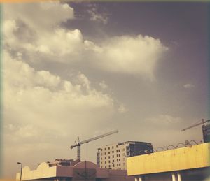 Low angle view of crane against sky