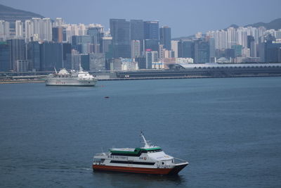 Ship in sea against buildings in city