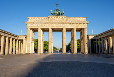 Low angle view of historical building against clear blue sky