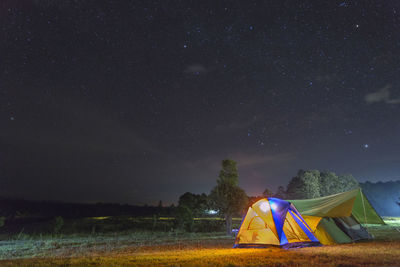 Tent on field against sky at night