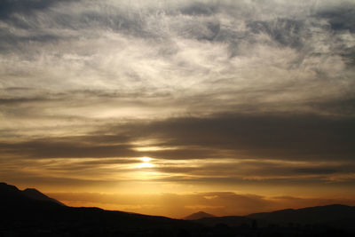 Scenic view of silhouette mountains against sky during sunset