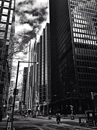 Buildings against cloudy sky