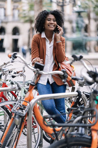 Young woman riding bicycle on city