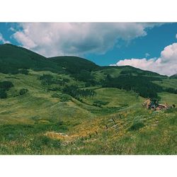 Scenic view of landscape against cloudy sky