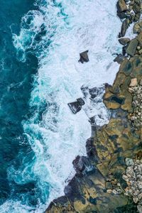 Directly above shot of rocks in sea