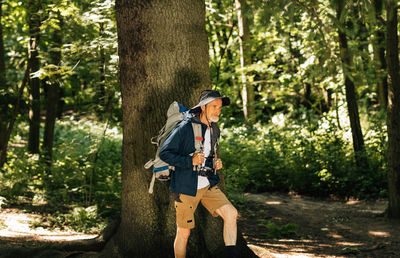 Full length of young woman walking in forest