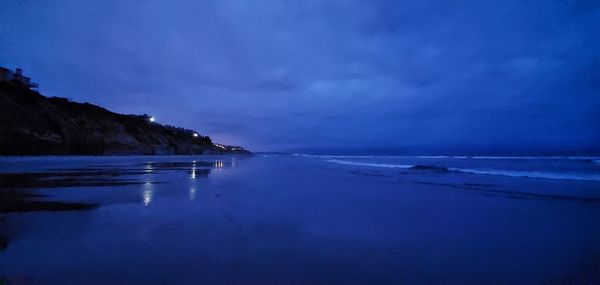 Scenic view of sea against sky at dusk