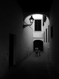 Man and boy standing in alley