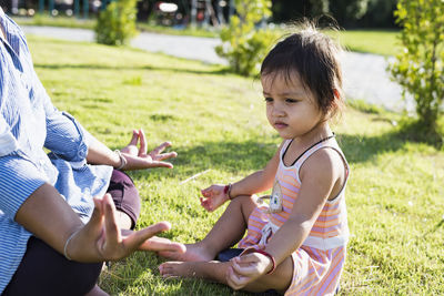 Side view of mother and daughter at park