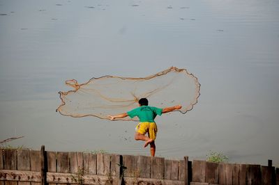 Full length of boy standing on railing