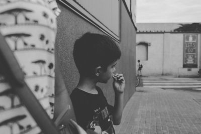 Boy in front of building