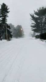 Snow covered landscape against sky