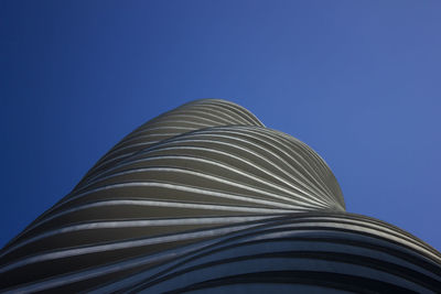 Low angle view of modern building against clear blue sky