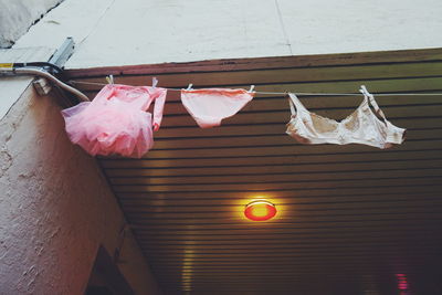 Low angle view of clothes drying on clothesline by building