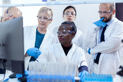 Midsection of scientist working in laboratory