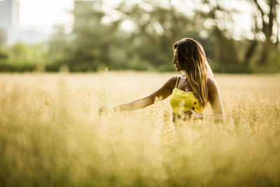 Side view of woman on field