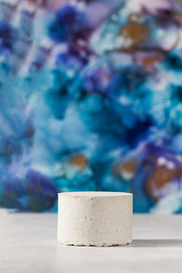 Empty concrete podium for the presentation of cosmetic products on a blue background. empty. 